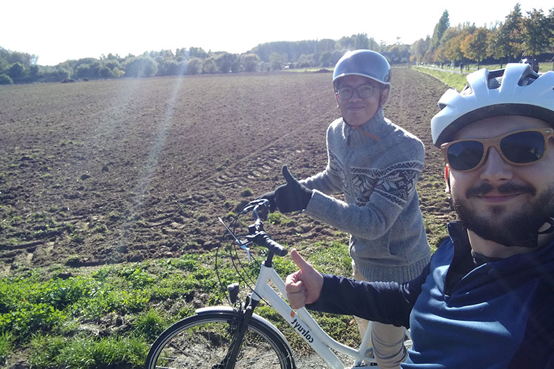 Saefur and his host dad on a bicycle